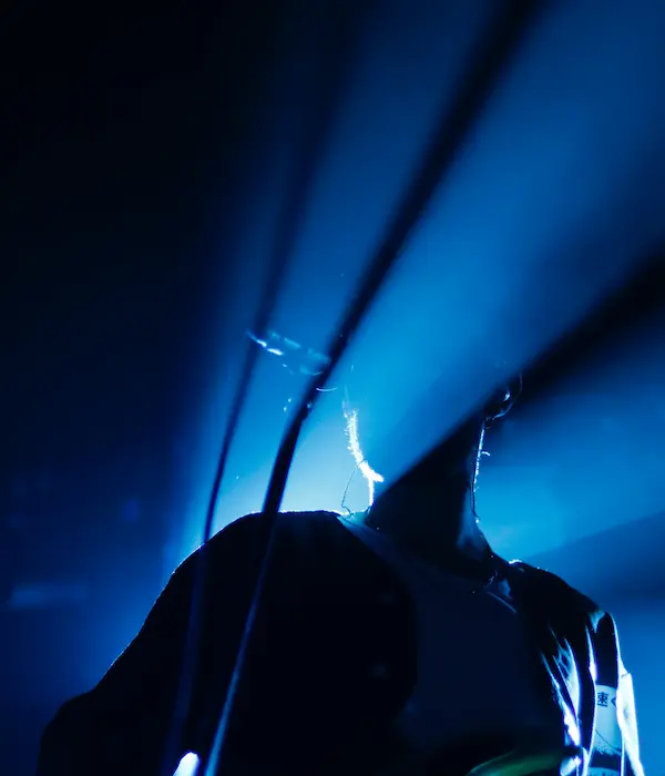 Silhouette of a singer performing with a blue background